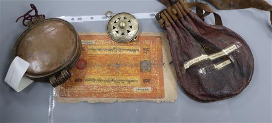 A group of Tibetan objects, including a flint lighter, a bullet bag, two pendants, a relic box and three banknotes